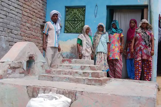 Muslim people standing in front of a grave inside their houe. Photo courtey 101reporters copy
